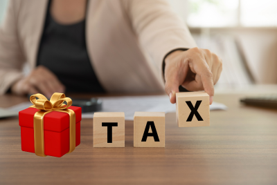 an image of a gift, then block letters that spell out "tax" directly after